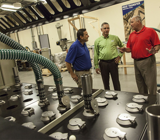 Conair staff discussing equipment
